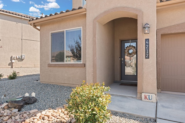 view of exterior entry featuring a garage