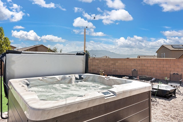 exterior space featuring a hot tub and a mountain view