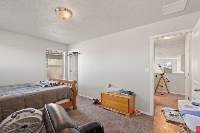 carpeted bedroom featuring a textured ceiling