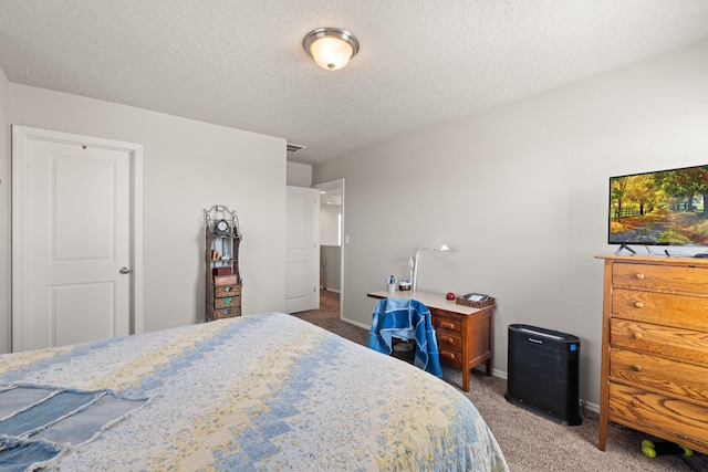 carpeted bedroom featuring a textured ceiling