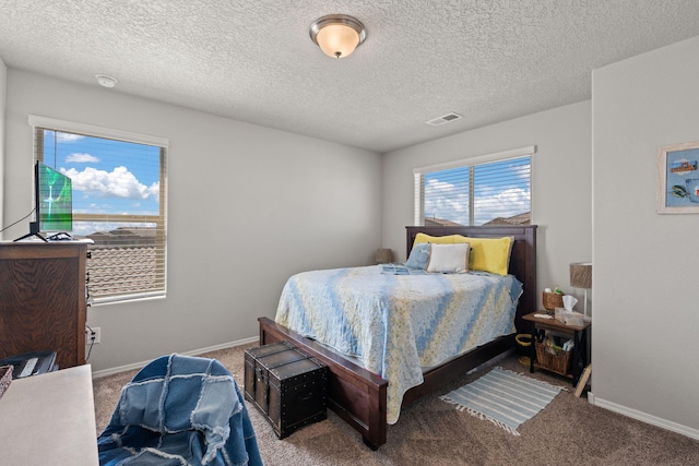 carpeted bedroom featuring a textured ceiling