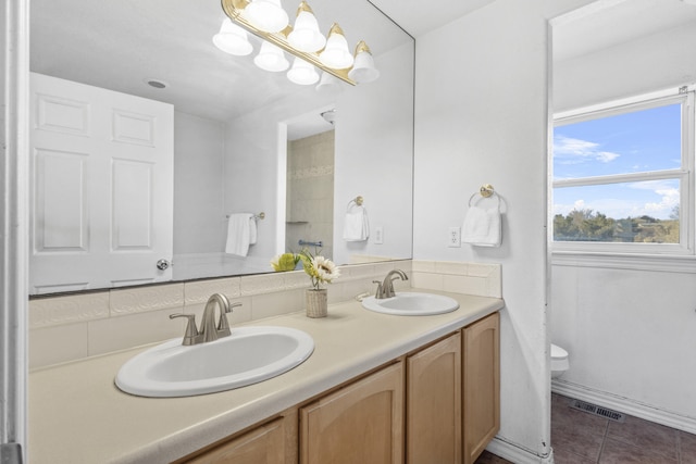 full bathroom featuring toilet, tile patterned flooring, visible vents, and a sink