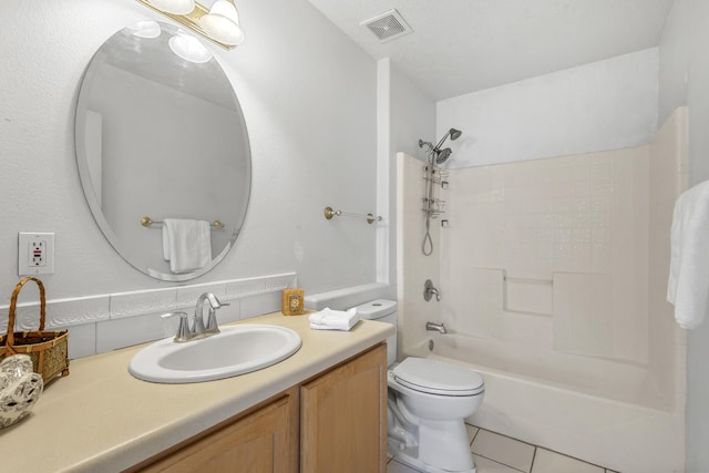 bathroom with toilet, vanity, visible vents, shower / washtub combination, and tile patterned floors