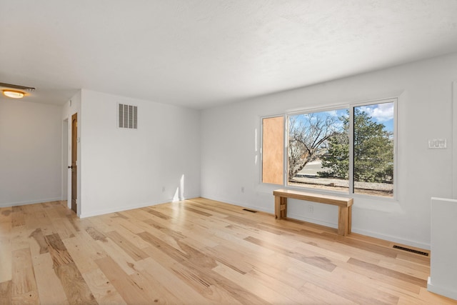 unfurnished room with light hardwood / wood-style flooring