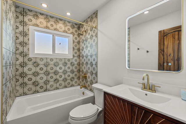 full bathroom featuring vanity, toilet, and tiled shower / bath combo