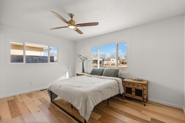 bedroom featuring light hardwood / wood-style floors and ceiling fan