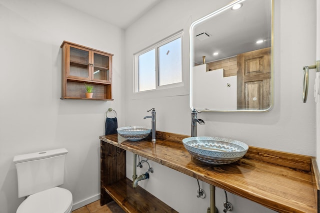 bathroom with tile patterned flooring and toilet