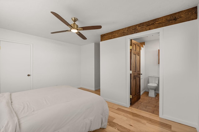 bedroom featuring connected bathroom, light hardwood / wood-style floors, and ceiling fan