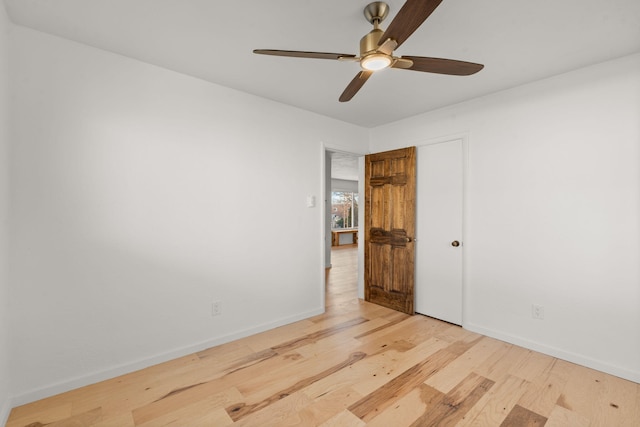 empty room featuring ceiling fan and light hardwood / wood-style floors