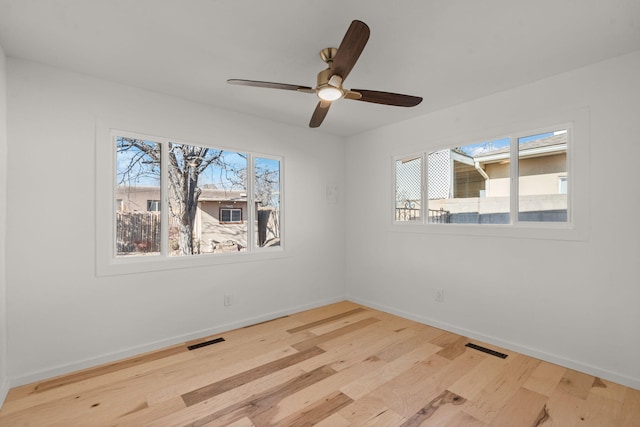 unfurnished room with hardwood / wood-style flooring and ceiling fan