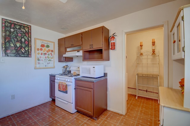 kitchen with a textured ceiling and white appliances