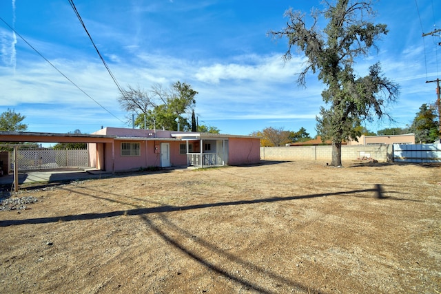 rear view of house featuring a yard