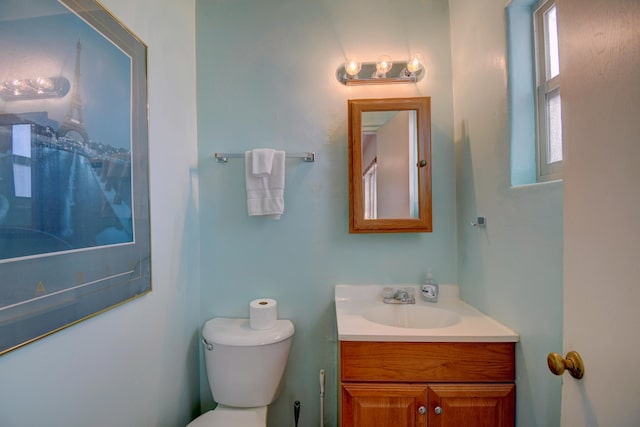 bathroom with toilet and vanity