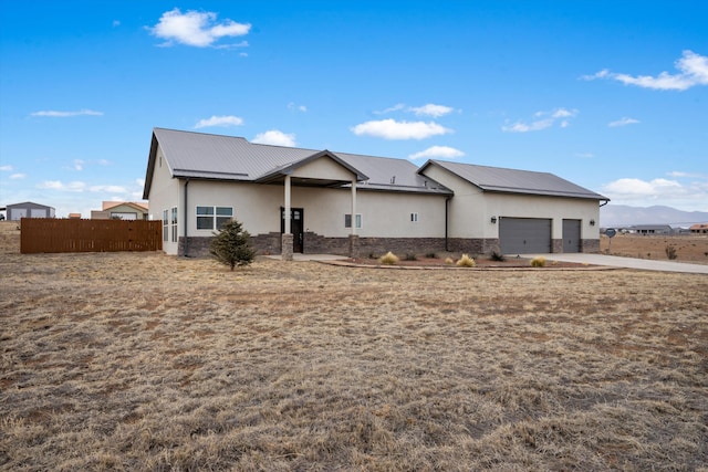 view of front of home with a garage and a mountain view