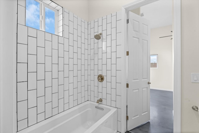 bathroom featuring tiled shower / bath