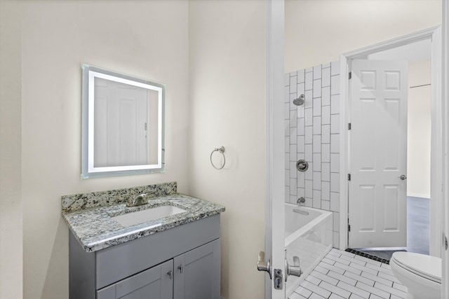 full bathroom featuring tiled shower / bath combo, tile patterned floors, vanity, and toilet