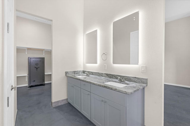 bathroom with vanity and concrete flooring