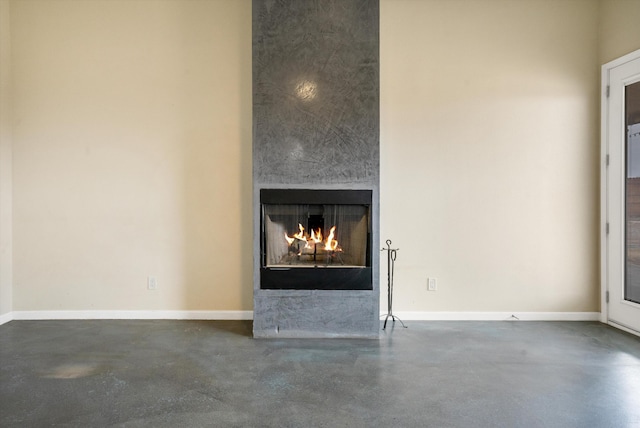 details featuring a large fireplace and concrete flooring