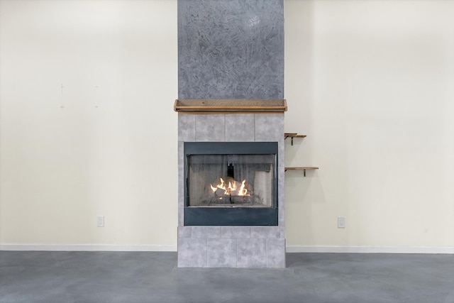 interior details with concrete flooring and a fireplace