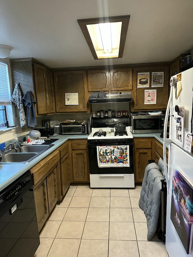 kitchen with sink, black dishwasher, light tile patterned floors, range with gas stovetop, and white refrigerator