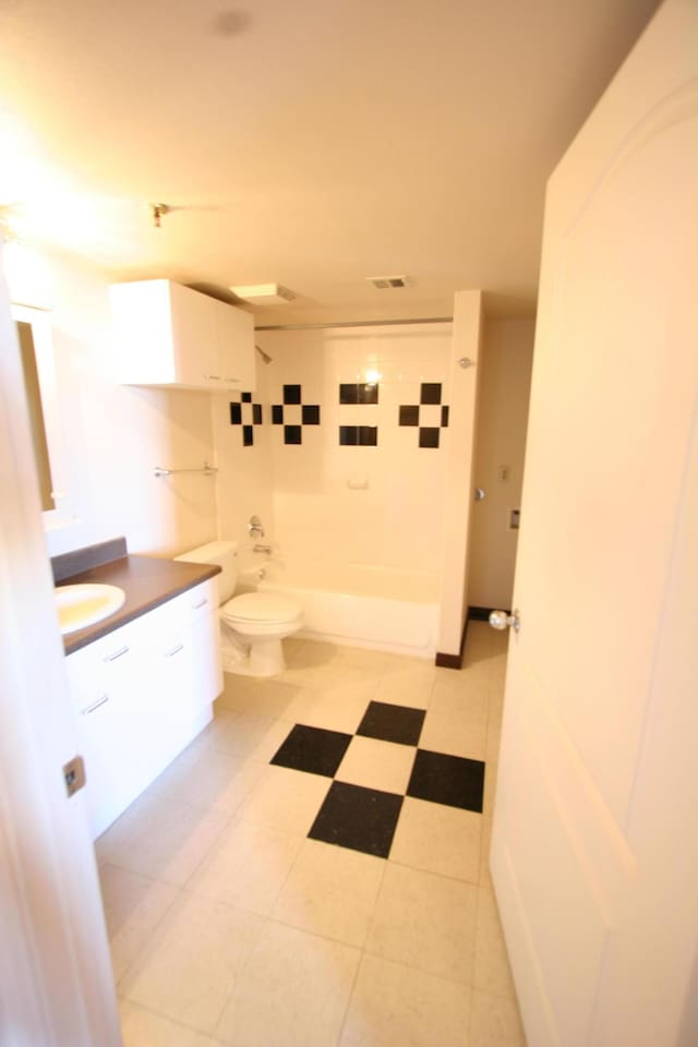 full bathroom featuring tiled shower / bath combo, toilet, and vanity