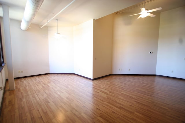 unfurnished room with ceiling fan and hardwood / wood-style floors