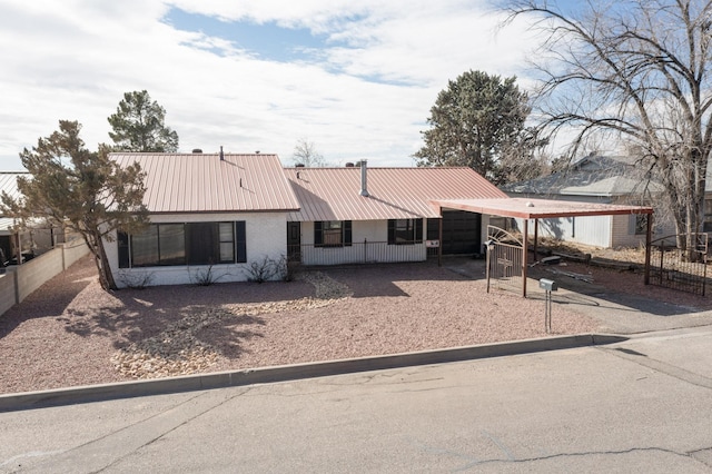 view of front of property featuring a carport