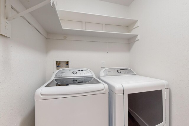 washroom with washing machine and clothes dryer