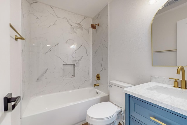 full bathroom featuring tiled shower / bath combo, vanity, and toilet