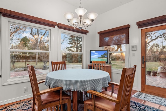 dining room featuring vaulted ceiling, a chandelier, and hardwood / wood-style flooring