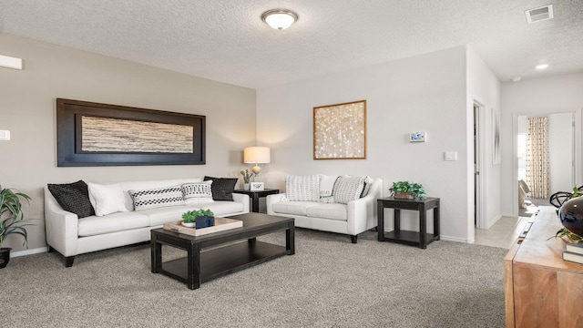 carpeted living room with a textured ceiling