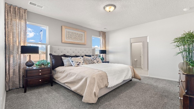 carpeted bedroom with a textured ceiling