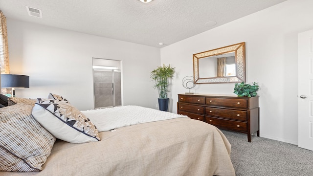 carpeted bedroom featuring a textured ceiling