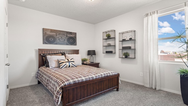 carpeted bedroom with a textured ceiling