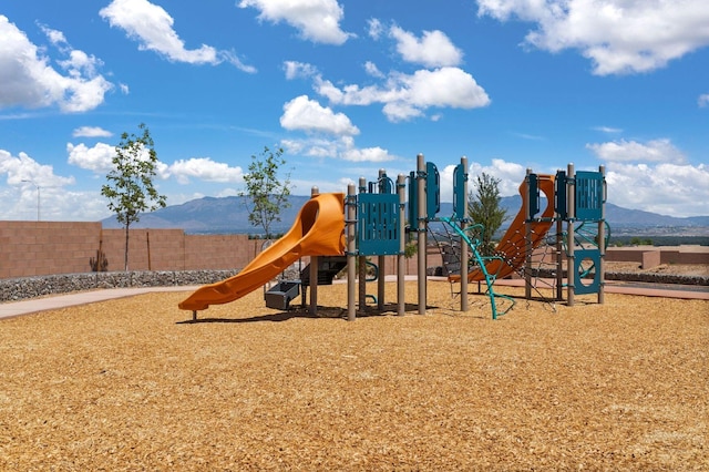 view of jungle gym with a mountain view