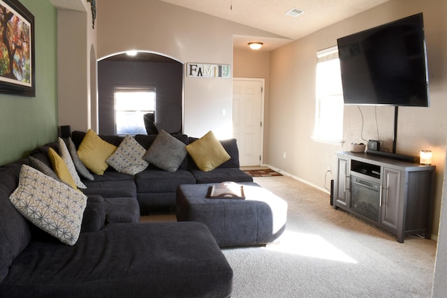 living room with lofted ceiling and light carpet