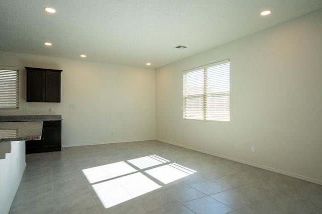 unfurnished living room with light tile patterned floors