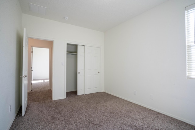 unfurnished bedroom featuring a closet and carpet floors