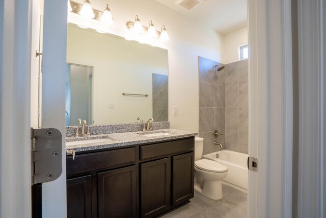 full bathroom with toilet, vanity, tiled shower / bath combo, and tile patterned flooring