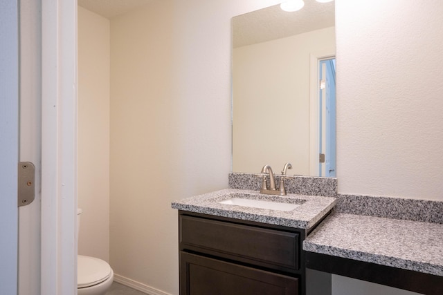 bathroom featuring toilet and vanity