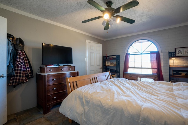 bedroom with ceiling fan, ornamental molding, and a textured ceiling