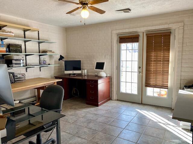 office featuring ceiling fan and a textured ceiling