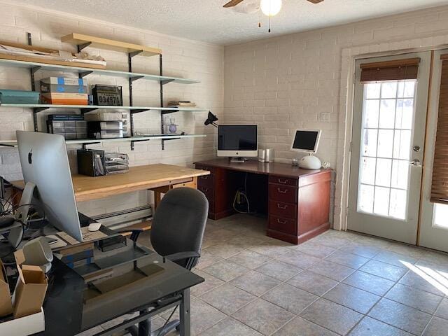 office featuring a wealth of natural light, a textured ceiling, and ceiling fan