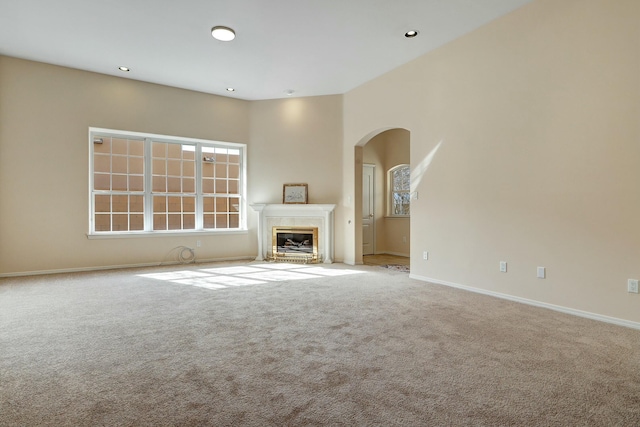 unfurnished living room featuring light colored carpet