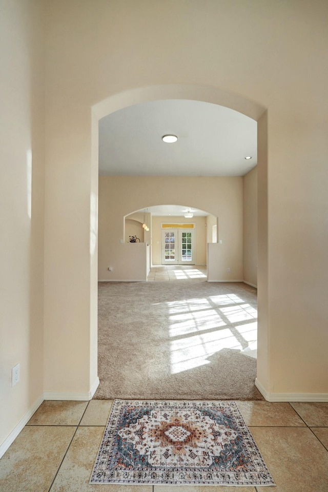 interior space featuring french doors and light tile patterned floors