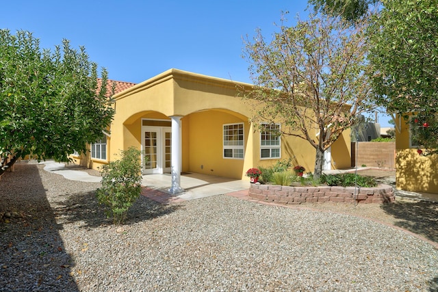 back of property featuring french doors and a patio area