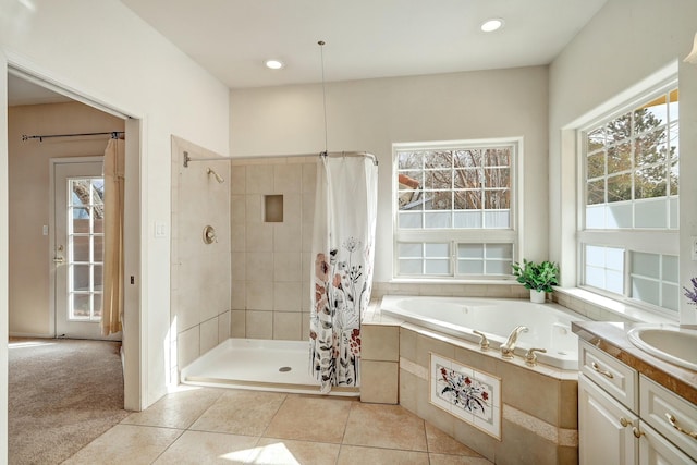 bathroom featuring tile patterned flooring, separate shower and tub, and vanity