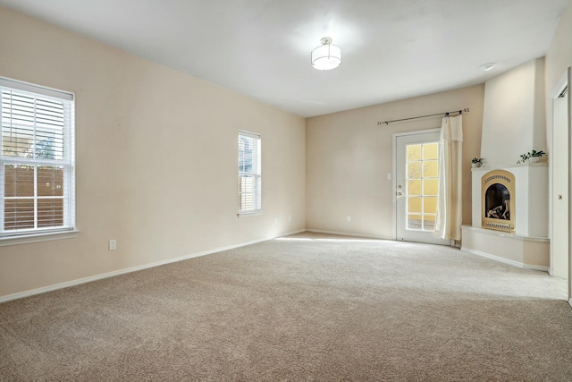 unfurnished living room with light carpet and a healthy amount of sunlight