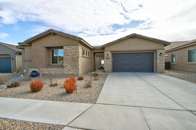 single story home featuring driveway, stone siding, an attached garage, and stucco siding