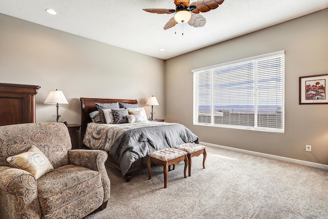 bedroom featuring light colored carpet and ceiling fan